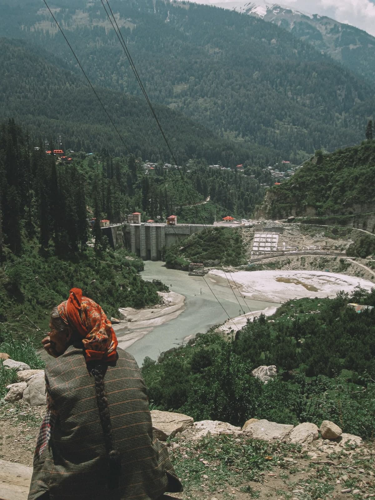 An old woman sitting at Kheerganga Path in Himachal.