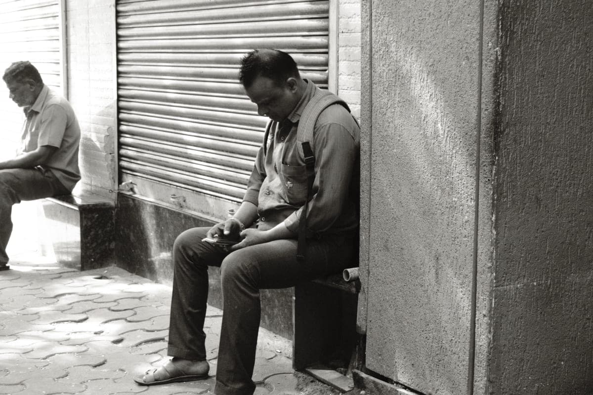 A Man sitting on a bench in Mumbai. Shot on Fujifilm X-T30II.